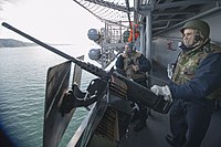 150123-N-RU971-031 - PO2 Kyle Shields mans M2 machine gun aboard USS Bonhomme Richard (LHD-6).jpg