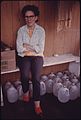 ALICE THOMPSON, BESOCO, WEST VIRGINIA, IS SHOWN WITH MILK BOTTLES HER NEIGHBORS FURNISH HER WATER WITH AFTER HER... - NARA - 556498.jpg