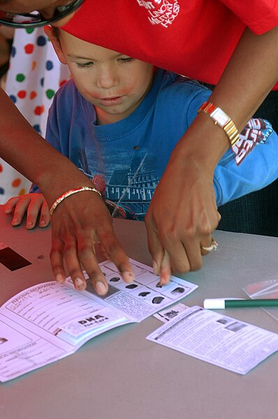 File:A young boy has his fingerprints taken for a child identification kit during America's Most Prepared Military Community (AMPMC) program at San Diego, Calif., on Sept. 9, 2006. AMPMC - DPLA - b8f19e82739e88d5ac999b66f23ee94c.jpeg