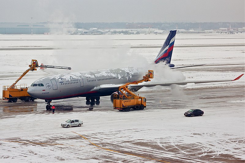 Deicing an airplane wing with lots of snow before takeoff : r