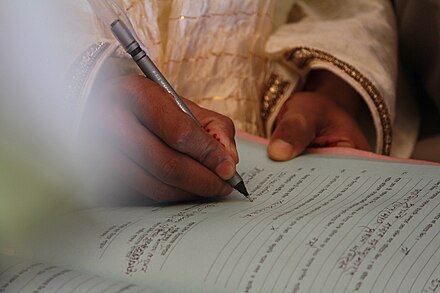Groom signing the marriage documents