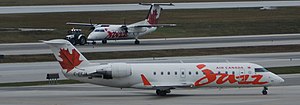 Bombardier CL-600-2B19 in Jazz Airlines livery with C-GJSX behind.jpg