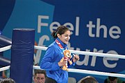 Deutsch: Boxen bei den Olympischen Jugendspielen 2018 Tag 12, 18. Oktober 2018 - Medaillenzeremonie im Fliegengewicht der Mädchen - Gold: Martina La Piana (Italien), Silber: Adijat Gbadamosi (Nigeria), Bronze: Heaven Destiny Garcia (USA); Medaillenübergabe durch Habu Gumel (IOC, Nigeria), Geschenkübergabe durch Dr. Joseph O. Ayeni (Nigeria, AIBA). English: Boxing at the 2018 Summer Youth Olympics on 18 October 2018 – Girl's flyweight Medal Ceremony - Gold: Martina La Piana (Italy), Silver: Adijat Gbadamosi (Nigeria), Bronze: Heaven Destiny Garcia (USA); Medal handover by Habu Gumel (IOC, Nigeria), Gift presented by Dr. Joseph O. Ayeni (Nigeria, AIBA). Español: Boxeo en los Juegos Olímpicos Juveniles de Verano de 2018 en 18 de octubre de 2018 - Ceremonia de la Medalla de peso mosca para niñas - Oro: Martina La Piana (Italia), Plata: Adijat Gbadamosi (Nigeria), Bronce: Heaven Destiny Garcia (Estados Unidos); Entrega de medallas por Habu Gumel (COI, Nigeria), Regalo presentado por Joseph O. Ayeni (Nigeria, AIBA).