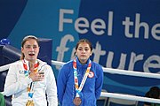 Deutsch: Boxen bei den Olympischen Jugendspielen 2018 Tag 12, 18. Oktober 2018 - Medaillenzeremonie im Fliegengewicht der Mädchen - Gold: Martina La Piana (Italien), Silber: Adijat Gbadamosi (Nigeria), Bronze: Heaven Destiny Garcia (USA); Medaillenübergabe durch Habu Gumel (IOC, Nigeria), Geschenkübergabe durch Dr. Joseph O. Ayeni (Nigeria, AIBA). English: Boxing at the 2018 Summer Youth Olympics on 18 October 2018 – Girl's flyweight Medal Ceremony - Gold: Martina La Piana (Italy), Silver: Adijat Gbadamosi (Nigeria), Bronze: Heaven Destiny Garcia (USA); Medal handover by Habu Gumel (IOC, Nigeria), Gift presented by Dr. Joseph O. Ayeni (Nigeria, AIBA). Español: Boxeo en los Juegos Olímpicos Juveniles de Verano de 2018 en 18 de octubre de 2018 - Ceremonia de la Medalla de peso mosca para niñas - Oro: Martina La Piana (Italia), Plata: Adijat Gbadamosi (Nigeria), Bronce: Heaven Destiny Garcia (Estados Unidos); Entrega de medallas por Habu Gumel (COI, Nigeria), Regalo presentado por Joseph O. Ayeni (Nigeria, AIBA).