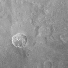 Bright crater within northern Manley crater. The crater has a ray system and the bright areas within it may be hollows.