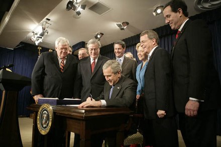 Santorum, at right, alongside seven other members of Congress and the Secretary of the Interior as President George W. Bush signs H.R. 6111, the Tax Relief and Health Care Act of 2006[35]