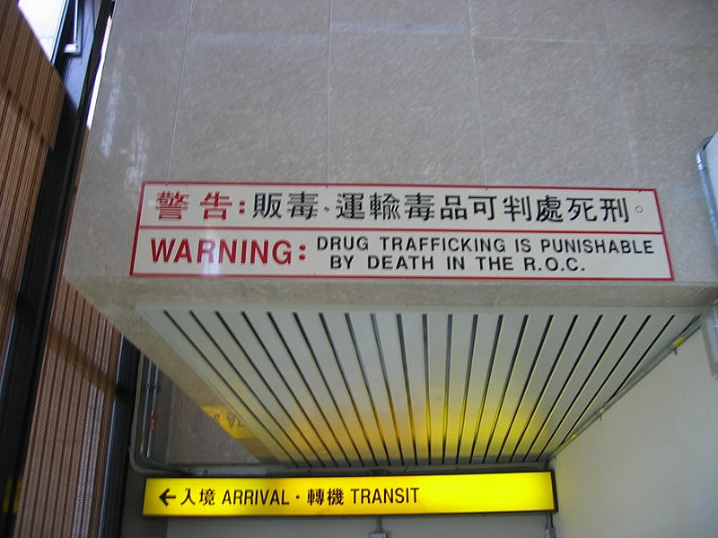 A sign at the Taiwan Taoyuan International Airport warns arriving travelers that drug trafficking is a capital offense in the "R.O.C." – the official name Republic of China and also known as Taiwan.[19]