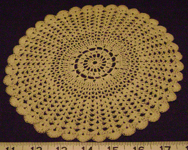 The outer half of this doily was done in a fan stitch. Crochet doily fan stitch.png