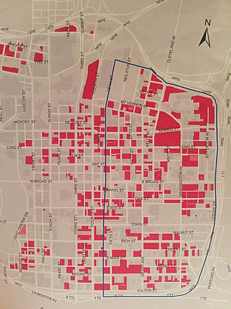 An outline of the Discovery District with red areas as an indication of parking lots located in the district in 2015 Discovery district.JPG
