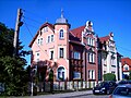 Double apartment building in open development (wood paneling)