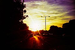 Sunset silhouetting a streetlight