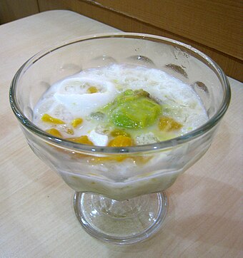 Indonesian dessert es teler, consisting of avocado, jackfruit, and young coconut in shredded ice and condensed milk.