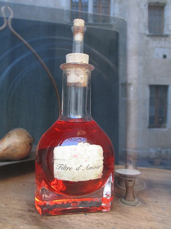 A bottle of colored liquid labelled as a love potion