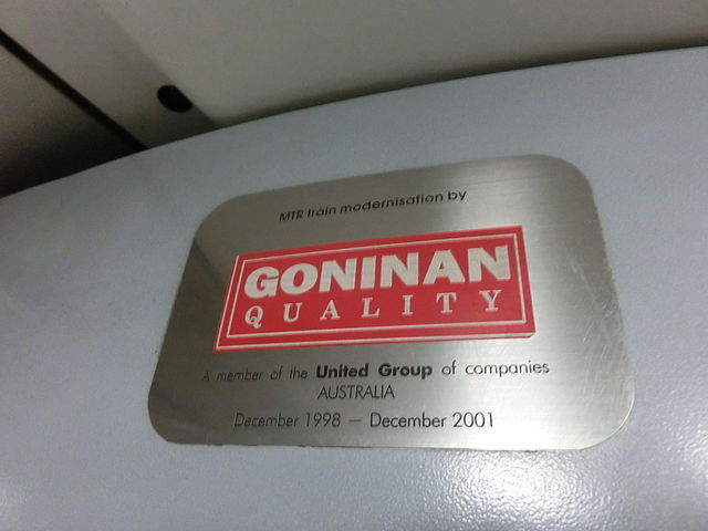 Metal plaque mounted inside an MTR Metro-Cammell EMU. The Plaque reads "MTR train modernisation by Goninan Quality, A member of the United group of companies, AUSTRALIA, December 1998 - December 2001"