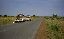 Two tourist vehicles stop for repairs on the main Niamey - Tahoua "Route Nationale", 1997. Highway to tahoua 2007 001.jpg