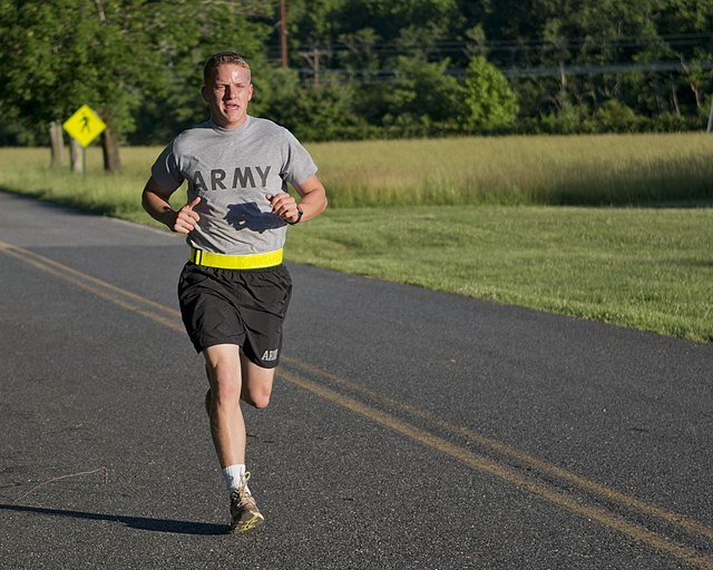 A U.S. Army soldier wearing sportswear runs to maintain his fitness.
