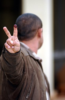 A voter showing a stained finger during the Iraqi election of 2005. Iraq-election2005-V.jpg