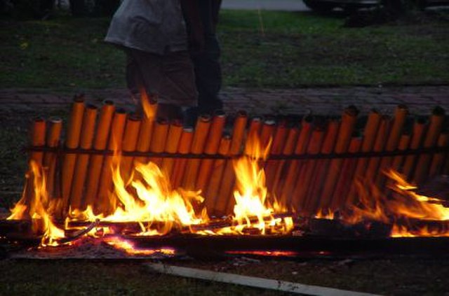 Lemang being cooked in hollow bamboo pieces