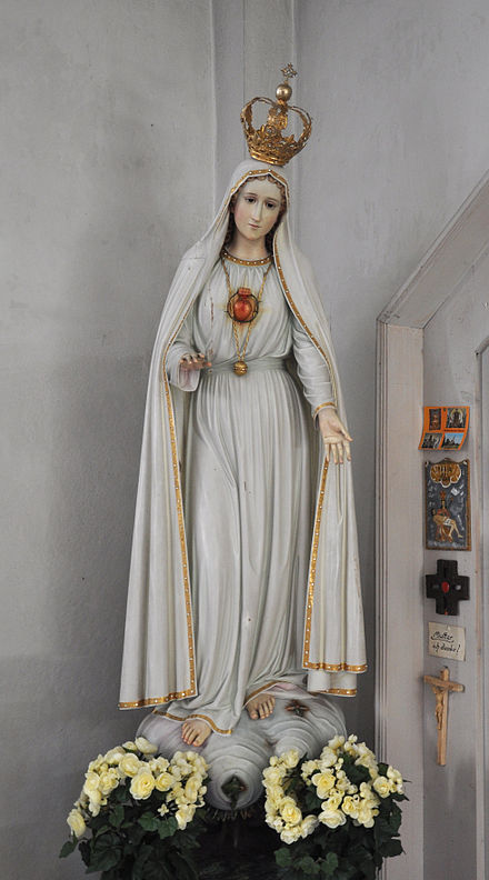 A religious statue depicting Our Lady of Fatima, with her Immaculate Heart surrounded with thorns, a necklace chain of golden ball (of light) and  barefooted as described by Sister Lúcia dos Santos at the Pontevedra and Fátima Marian apparitions.