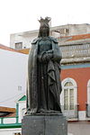 Statue of Queen Leonor, founder of Caldas da Rainha, standing regally on Largo Conde de Fontalva, more popularly known as Largo da Rainha (Queen's Square).