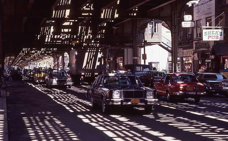 File:Roosevelt-avenue-queens-nyc cars driving-under-elevated-railway-line 1980s.jpg