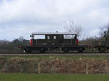 Preserved SR "Queen Mary" bogie brake van - most British brake vans had just four wheels and a rigid wheelbase. This one has all three side lamps visible. SR Queen Mary 56290.JPG