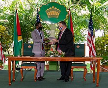 Guyanese foreign minister Hugh Todd (left) and US Secretary of State Mike Pompeo (right) at a signing ceremony in Georgetown, Guyana in 2020 during the COVID-19 pandemic Secretary Pompeo and Guyanese Foreign Minister Todd Participate in the Growth in America Agreement Signing Ceremony (50368594846) (cropped).jpg