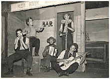 The Bushwhackers on the set of the play "Reedy River", 1953-1954. L-R: Harry Kay, Cecil Grivas, John Meredith, Brian Loughlin, Chris Kempster. The Bushwhackers on the set of the play "Reedy River", 1953-1954, (1) J.C. Parker (16837779631).jpg