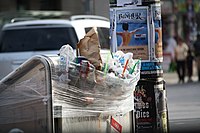 Trash seen being put into the plastic covering sealed trash bins on June 22. Toronto Strike - Garbage Bin.jpg