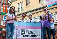 Members of El/La Para TransLatinas speak on a stage in the Compton's Transgender Cultural District, at the 2019 San Francisco Trans March. Trans March San Francisco 20190628-7706.jpg