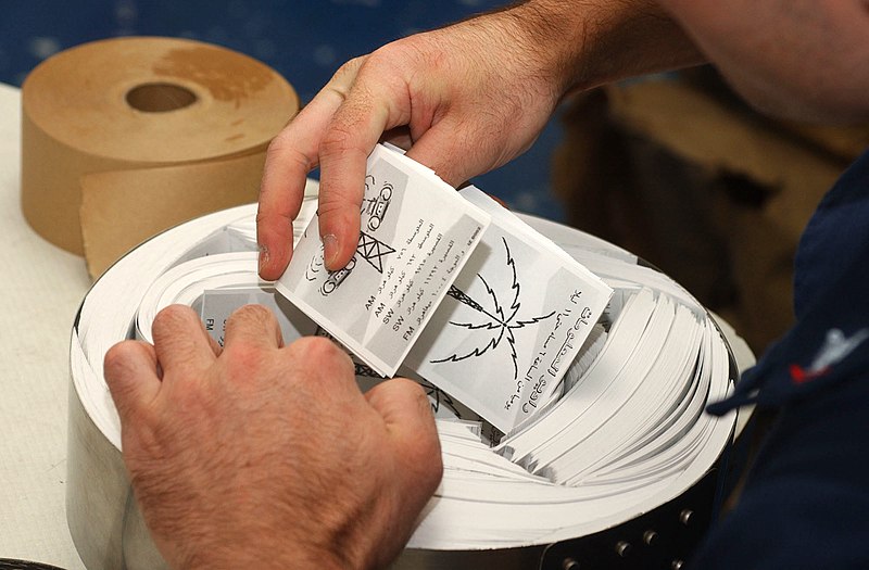 File:US Navy 021230-N-4655M-005 loading leaflets into canisters.jpg