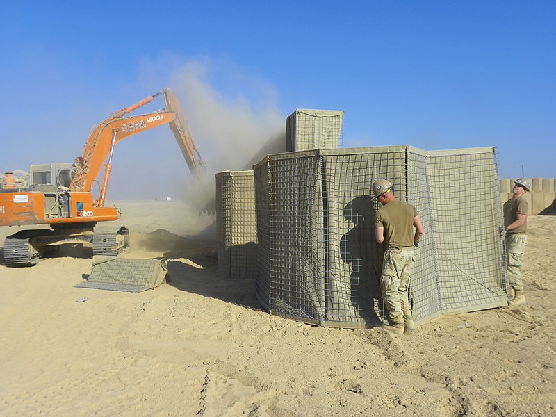 File:US Navy 101120-N-7743H-041 Seabees assigned to Naval Mobile Construction Battalion (NMCB) 18 and an Afghani contractor operating an excavator build.jpg