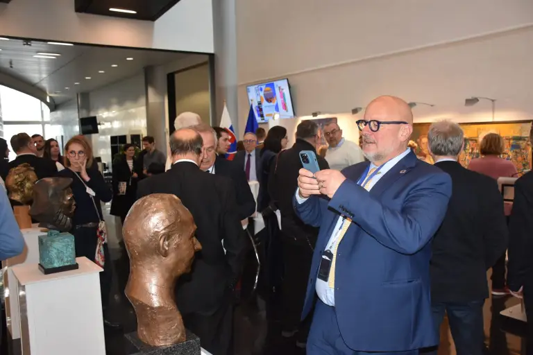 File:Vice President of the European Parliament Marg Angel takes a picture of the bust of Alexander Dubček at the SZPB and Slovak Matica exhibition in Strasbourg.webp