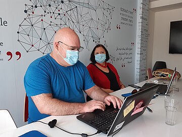 A volunteer provides individual instruction to a graduate of the Senior Citizens Course