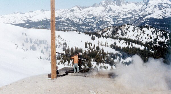 U.S. Forest Service team using a 106 mm (4.2 in) Recoilless Rifle for avalanche control at Mammoth Mountain; Minarets in background.