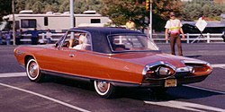 Red Chrysler Turbine Car in a parking lot