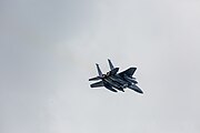 An F-15E Strike Eagle, tail number 91-0302, taking off from RAF Lakenheath in England. The aircraft is assigned to the 492nd Fighter Squadron.