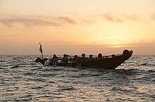 Chumash paddlers navigate a tomol near Santa Cruz Island (2015) CINMS - Tomol Crossing Sunrise .jpg