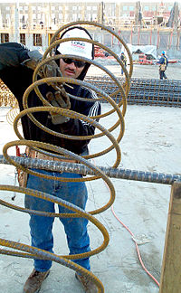 A construction worker with column reinforcement steel Construction worker.jpeg