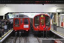 The D78 Stock and its replacement, the S7 Stock, at Ealing Broadway on the final day of D78 Stock operation. D Stock and S Stock side by side on last day of D Stock operation.jpg