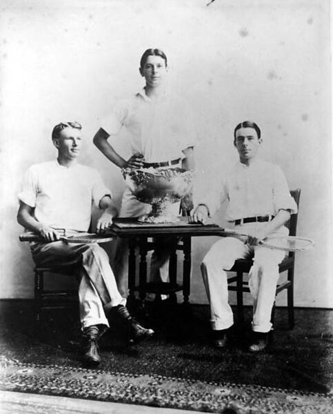 American player Dwight Davis (center) in 1900 with the trophy he committed to build.