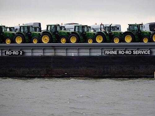 Detail of John Deere tractors transported by a barge on the Oude Maas river