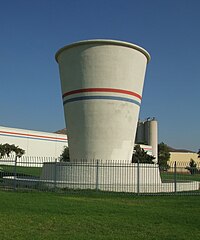 The world's largest "paper" cup in front of what was once the Lily-Tulip manufacturing company, later Sweetheart Cup Company. Made of poured concrete, the cup stands about 68.1 feet (20.8 m) tall. Dixie Cup 20090904.jpg