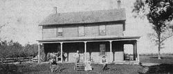 The south-facing side of the Gibbs farm house with family outside. The oak tree to the right of the photograph still exists today. GHAUS.JPG