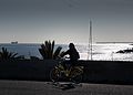 Girl on Yellow Bike in Barcelona harbour.