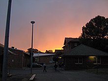 The boarding school at sunset. Several dormitories, a kitchen, and dining room are visible. Hurlstone boarding school.jpg