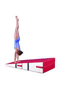 Gymnast performing handstand on a folding incline.