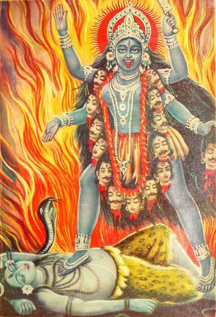 Modern depiction of the Hindu goddess Kali, shown standing atop Shiva, wearing a necklace of severed heads, in front of a fiery background