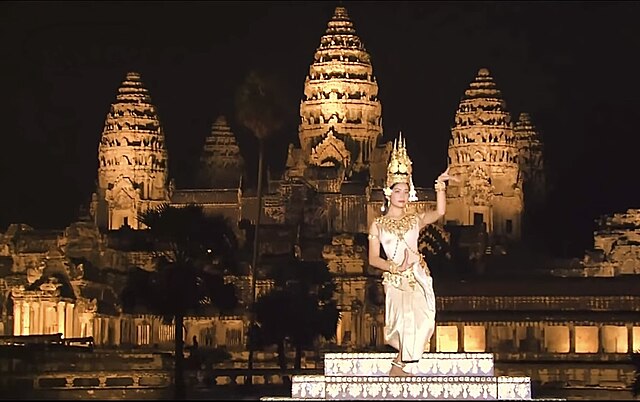 Apsara dancer in front of Angkor Wat, two Cambodian cultural symbols.