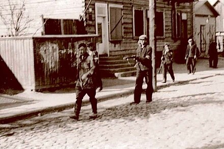 Lithuanian resistance fighters lead the arrested Commissar of the Red Army in Kaunas, 1941